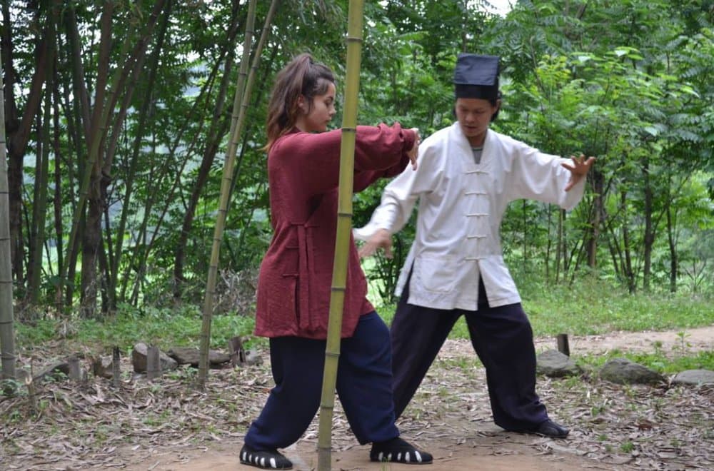 Sabina practicing with a sword outdoors